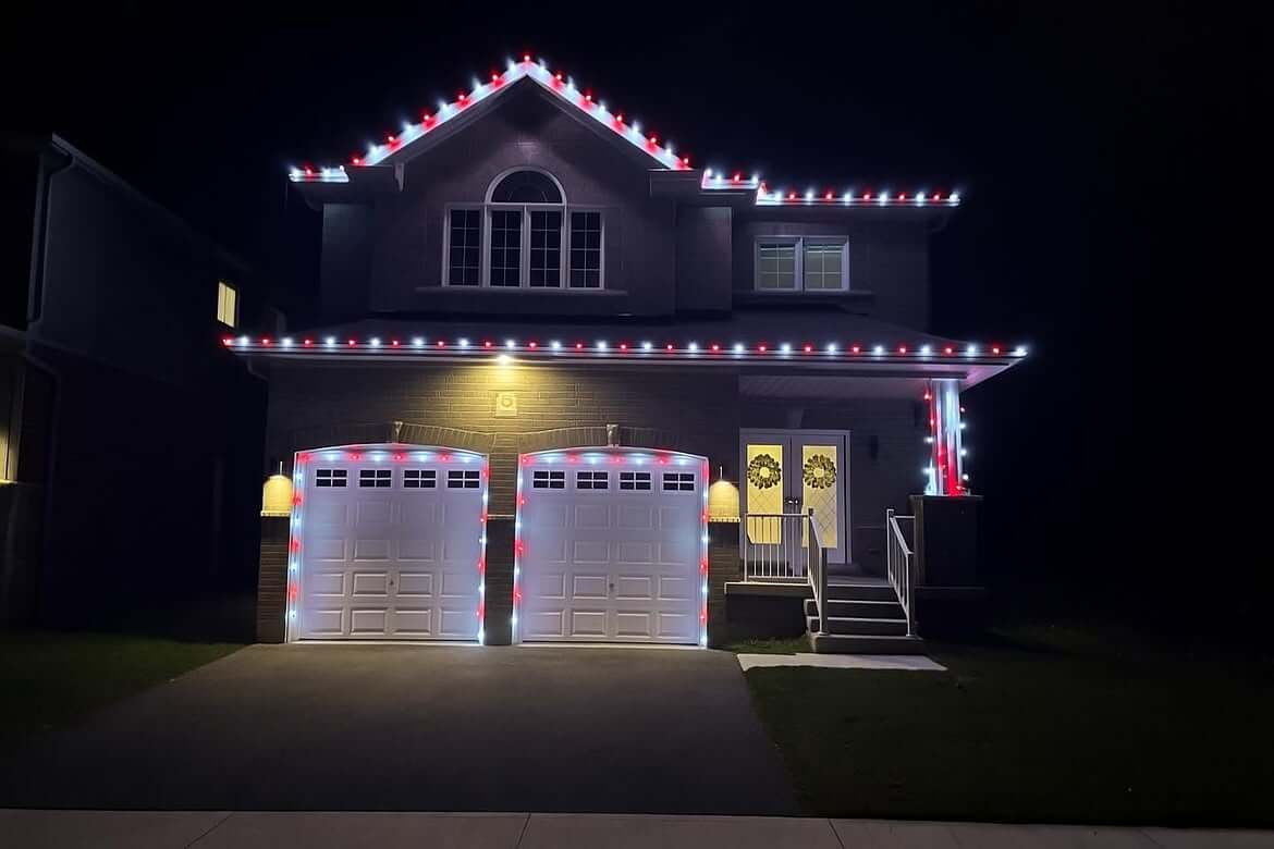 Permanent red and white architectural lighting outlining a home in Durham Region