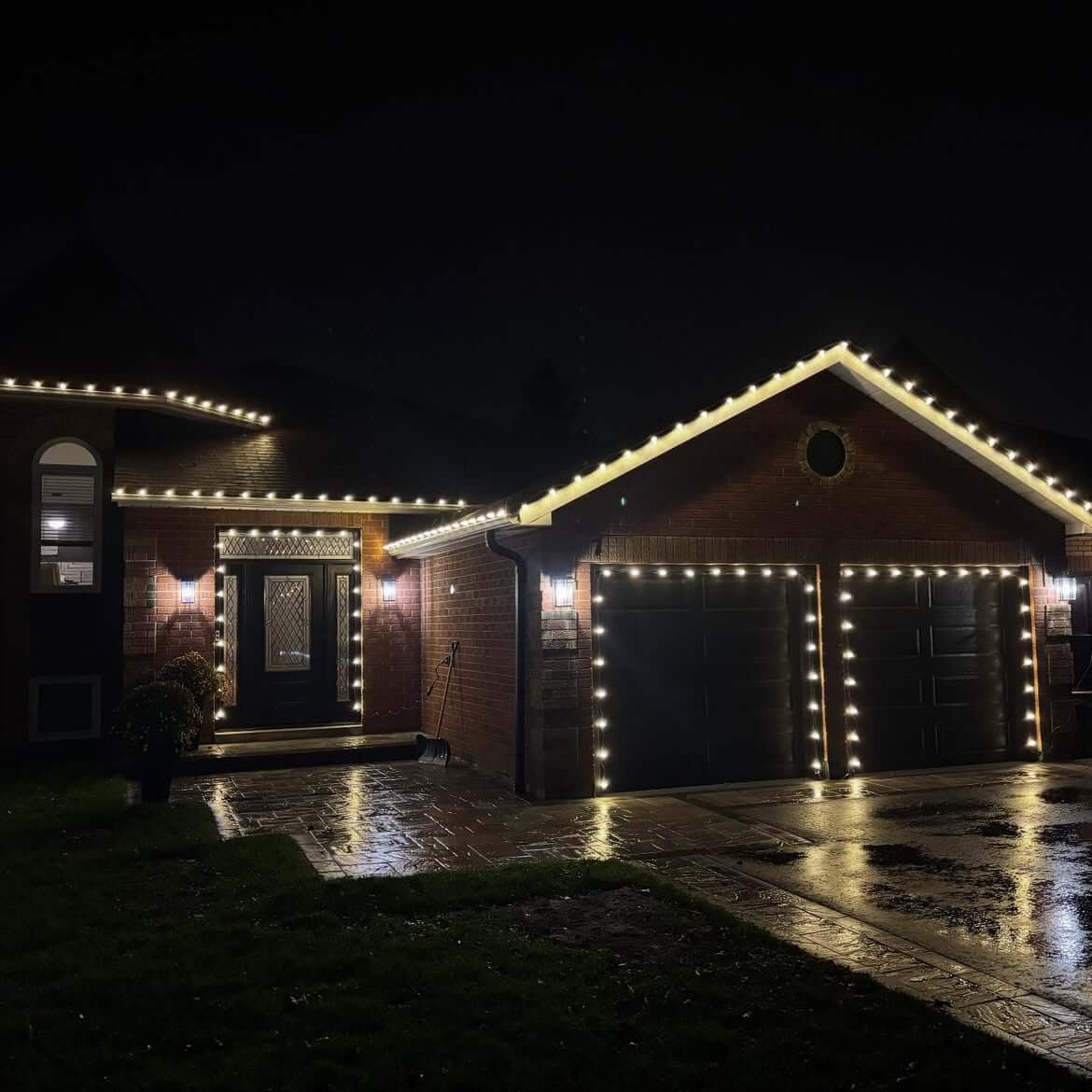 Warm white C9 lights wrapped around columns and door frame of a bungalow in Durham Region